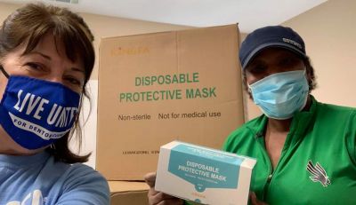 ladies with masks at food drive