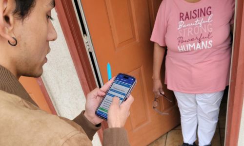 Volunteer conducting survey at motel shelter