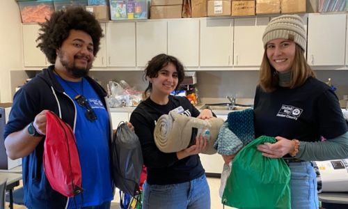 Volunteers with survival bag items